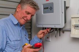 An electrician checking on an electrical switchboard. Never DIY your electrical work. Contact a licensed electrical contractor in Bardon and surrounds (Alderley, Ashgrove, Enoggera, Paddington, The Gap) like Allyn White Electrical for all of your electrical problems.